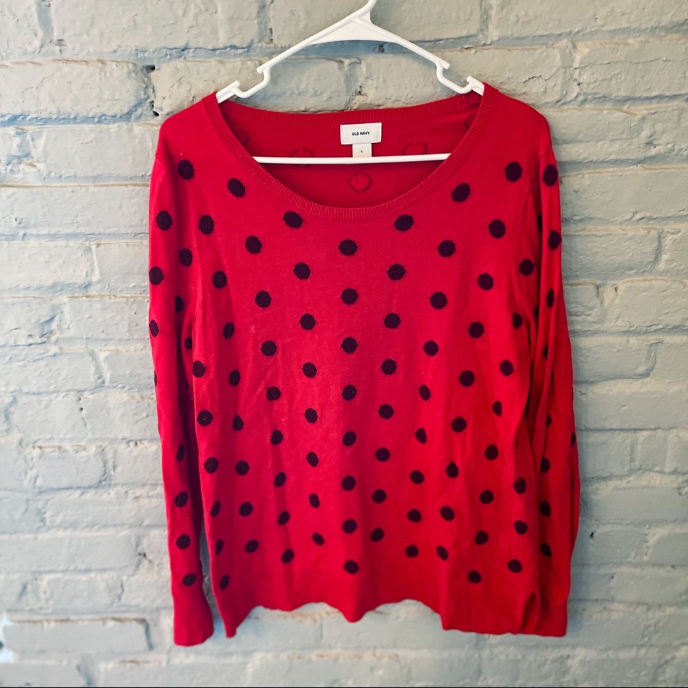 Bright orange sweater with maroon polka dots